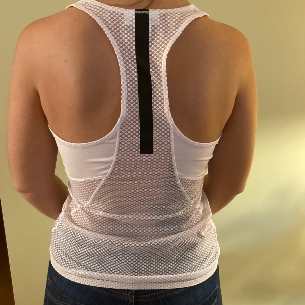 White Reebok workout tank top with mesh sides and back.